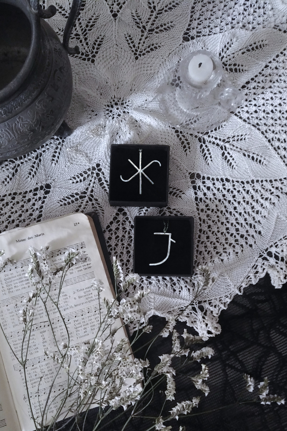 Talismans inspired by Hildegard von Bingen's Litterae Ignotae alphabet, on a doily